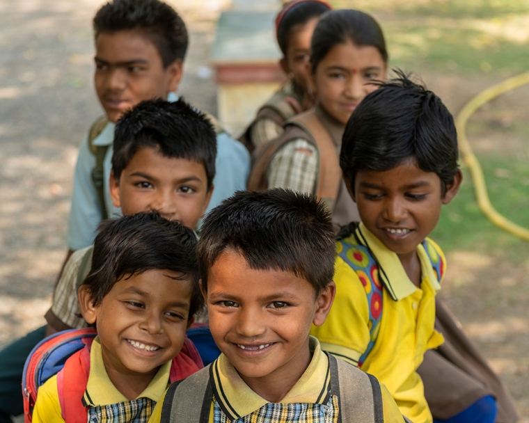 Rajesh smiling with schoolmates