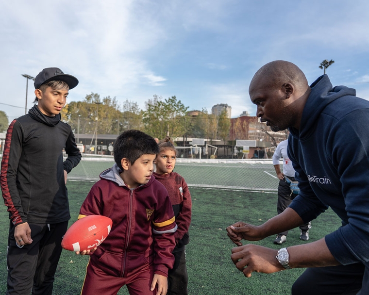 Mathias with participants at his football clinic