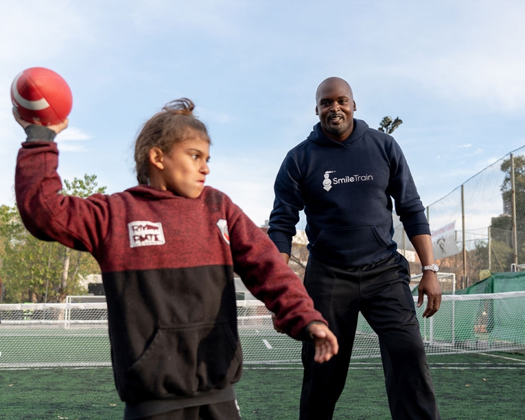 Mathias teaching a clinic participant how to throw