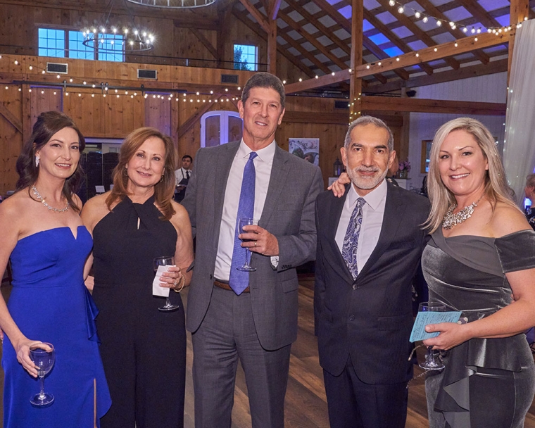 Sara smiling with her family at Sadie's Gala