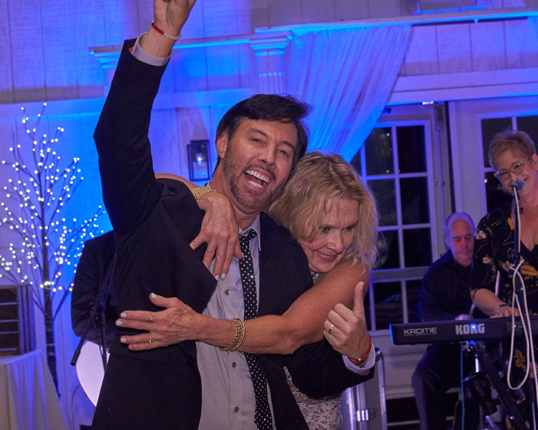 Troy Reinhart smiling and dancing at Sadie's Gala