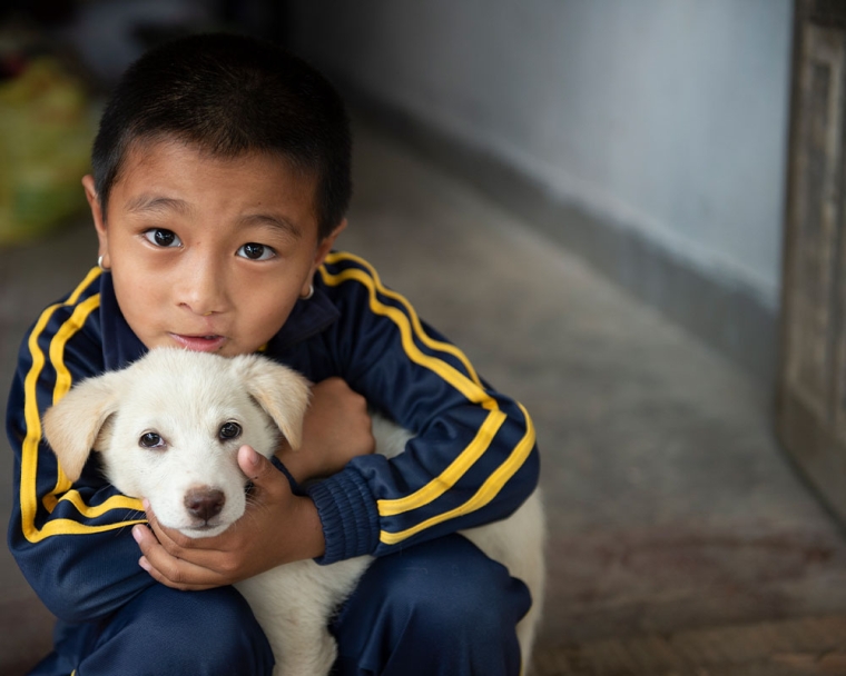 Jenious hugging his puppy