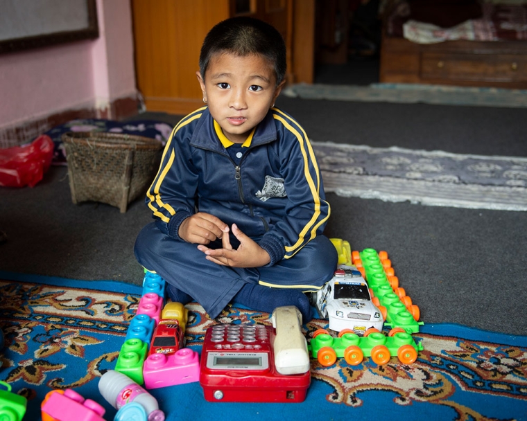 Jenious playing with his toys