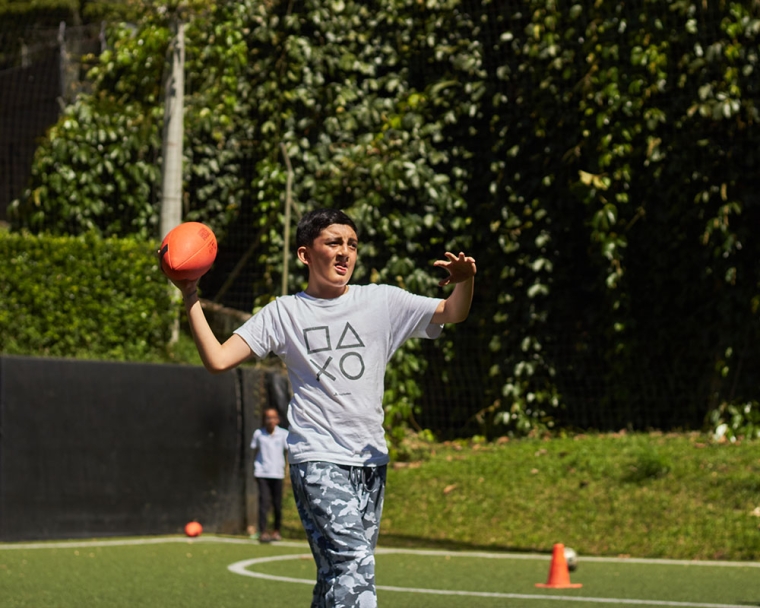 Smile Train patient throwing a football