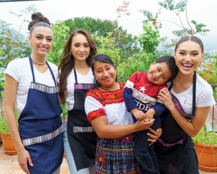 Miss Universe Organization smiling with Smile Train patients and parents