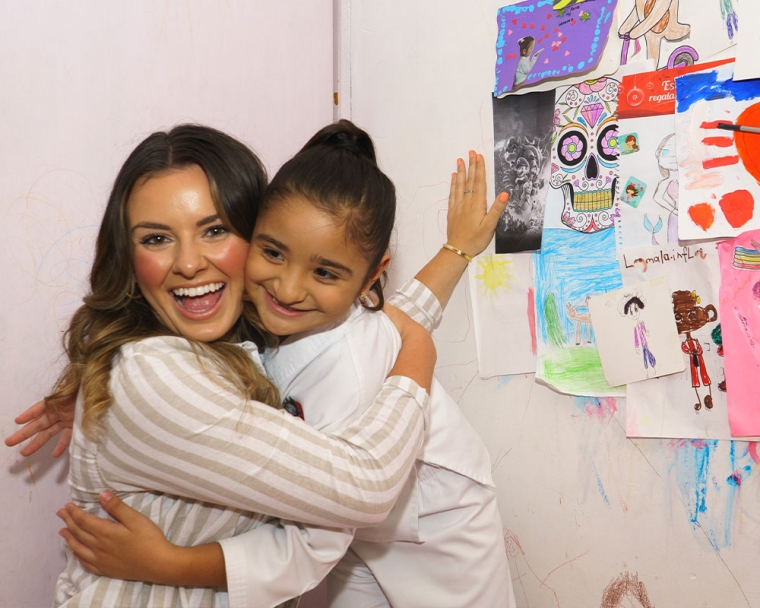 Tammy smiling and giving a patient a hug