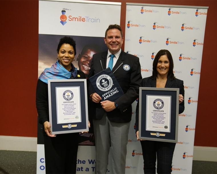 Guinness World Records adjudicator standing and smiling with Susannah Schaefer and Erania Brackett