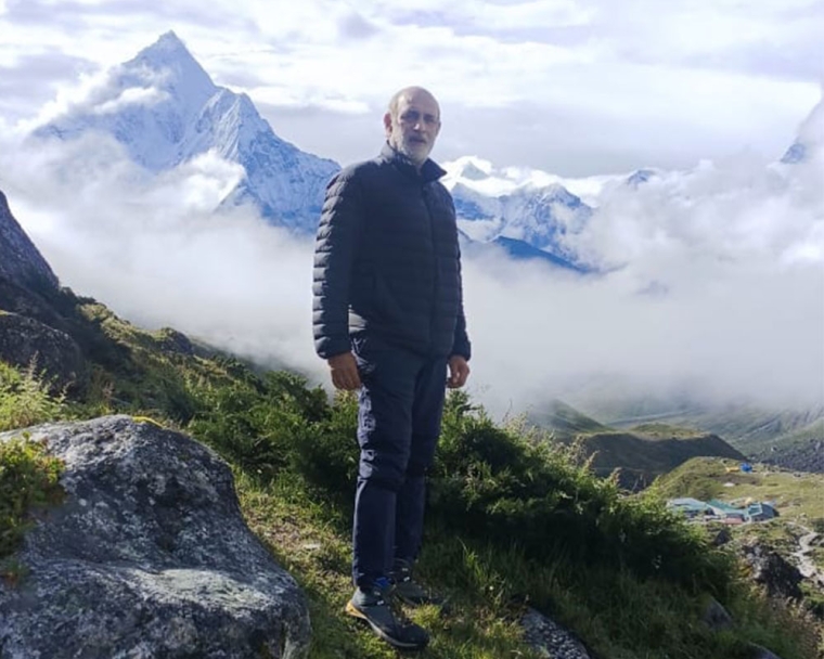 Sunil Tuli standing on a mountaintop