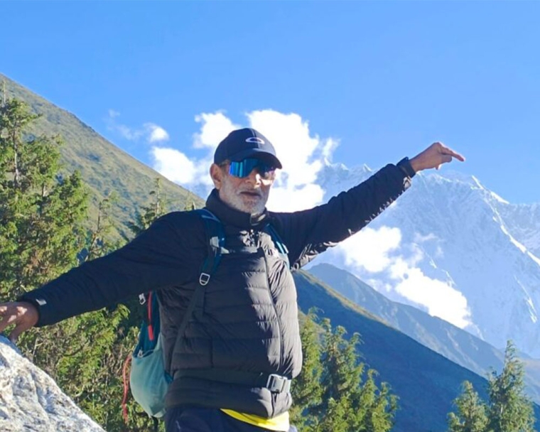 Sunil Tuli standing on a mountaintop