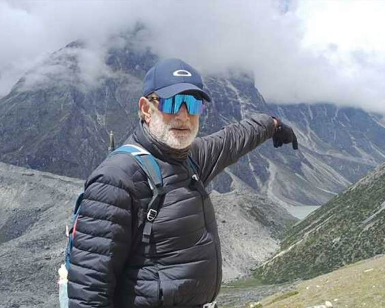 Sunil Tuli standing on a mountaintop