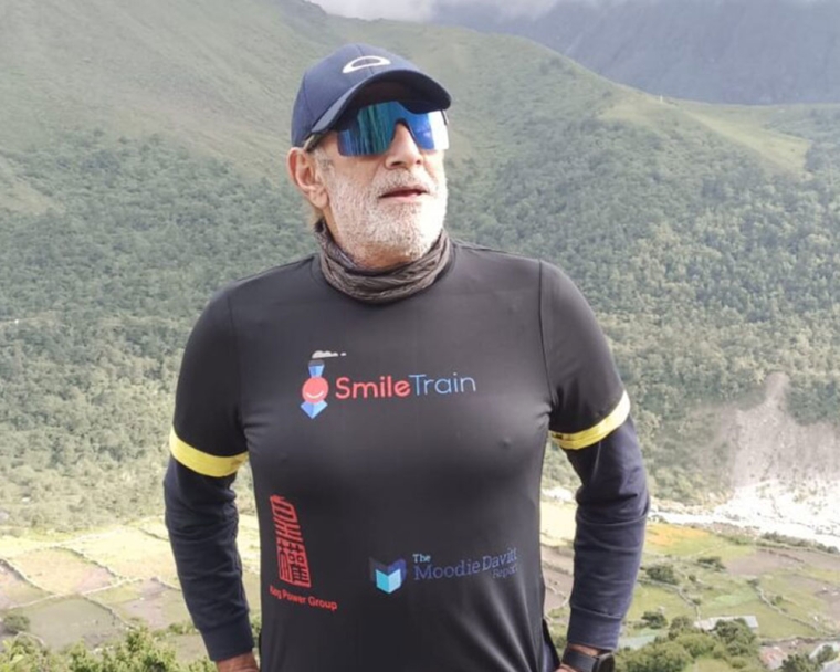 Sunil Tuli standing on a mountaintop