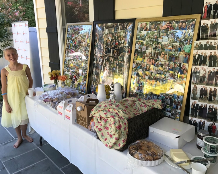 Ella smiling next to a table of refreshments