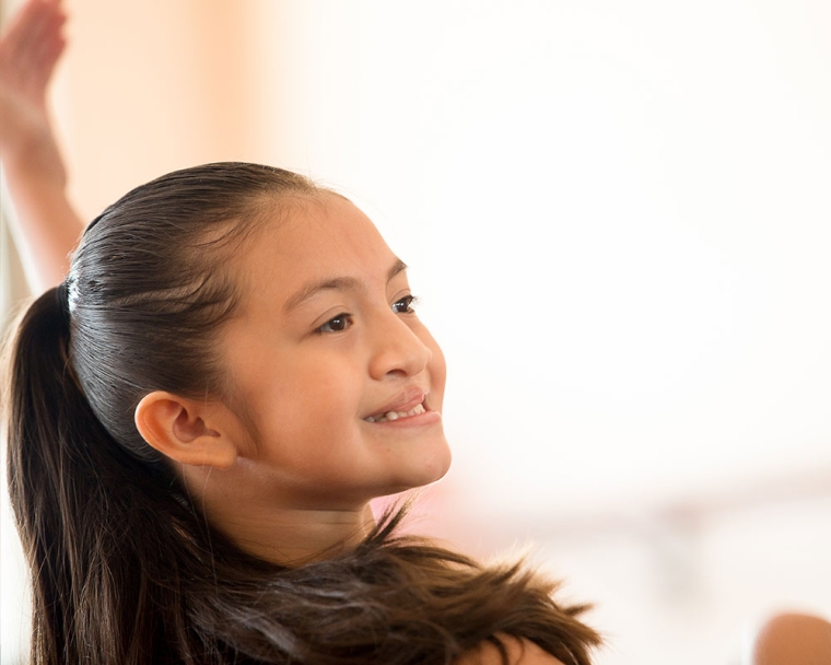 Aquetzaly smiling and doing a ballet move