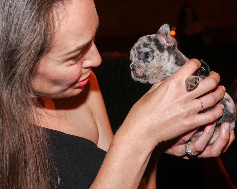Smile Train Chief Programs Officer Erin Steiber holds a puppy with a cleft