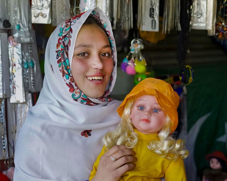 Sheema smiling and holding a doll after cleft surgery