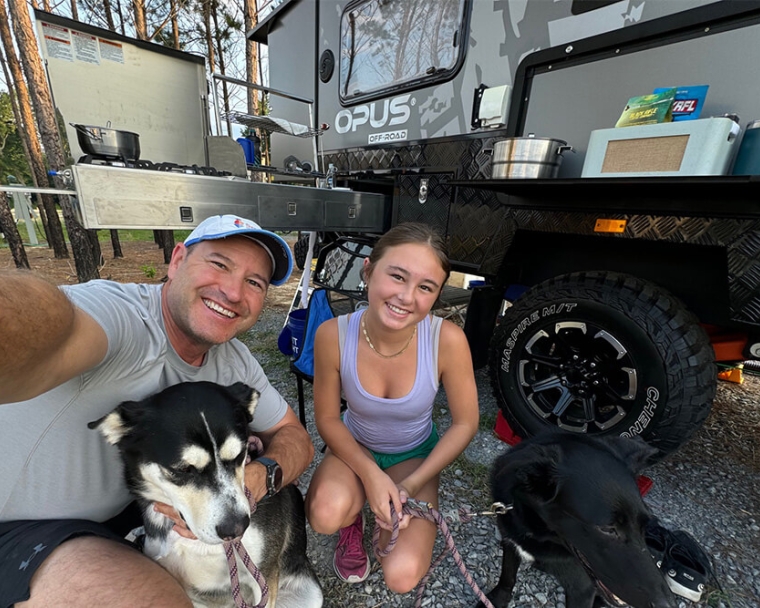 hough family smiling with their two dogs