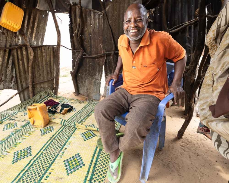 Adan smiling and sitting at home after cleft surgery