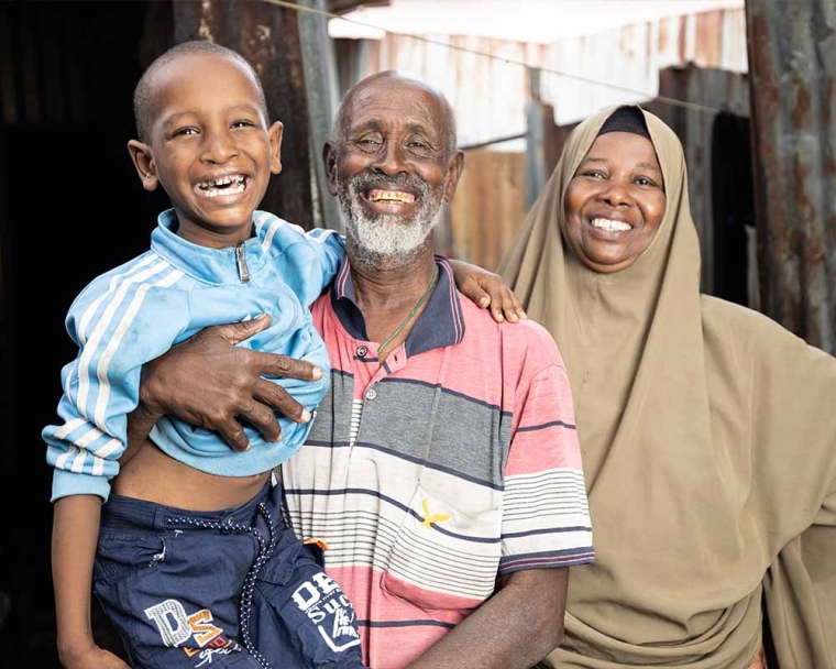 Omar smiling with his parents after cleft surgery