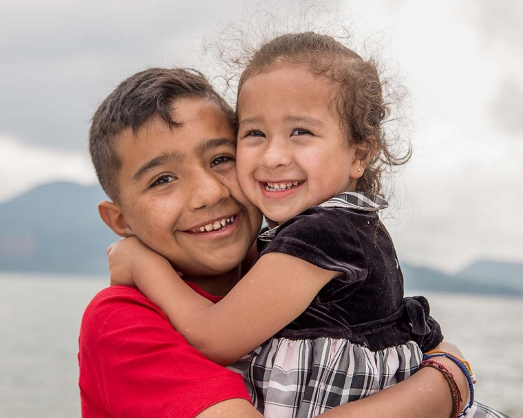 Jesus smiling and hugging his sister after cleft surgery