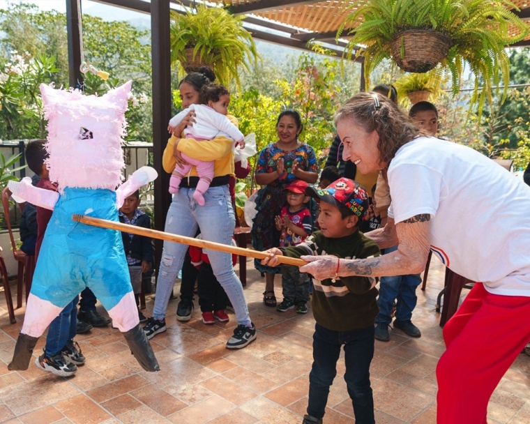 Karen playing with a piñata