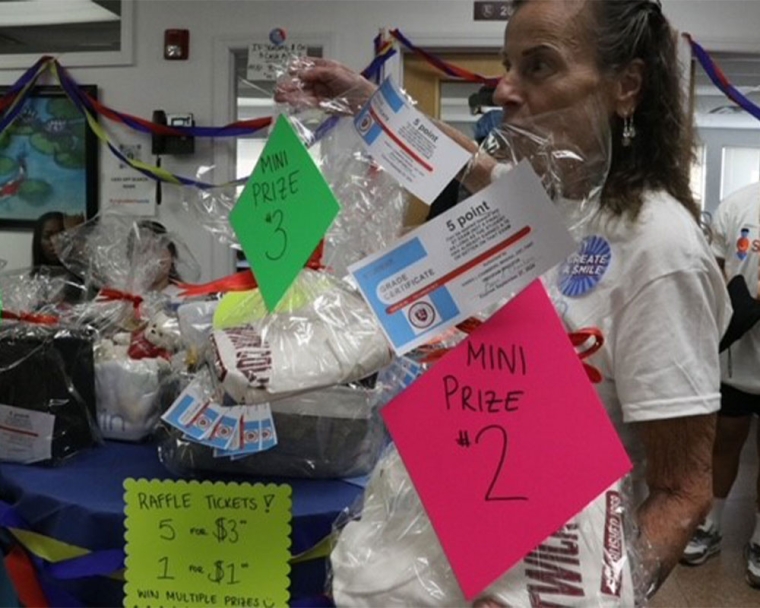 Karen Chambers holding prizes