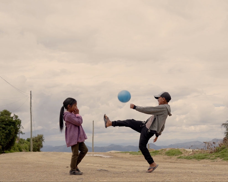 Diego juggling a soccer ball with his sister after cleft surgery