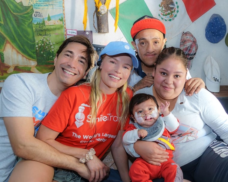 Justing Long and Kate Bosworth smiling and hugging Smile Train patients in Mexico