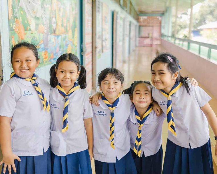 Pim and her friends smiling after her cleft surgery