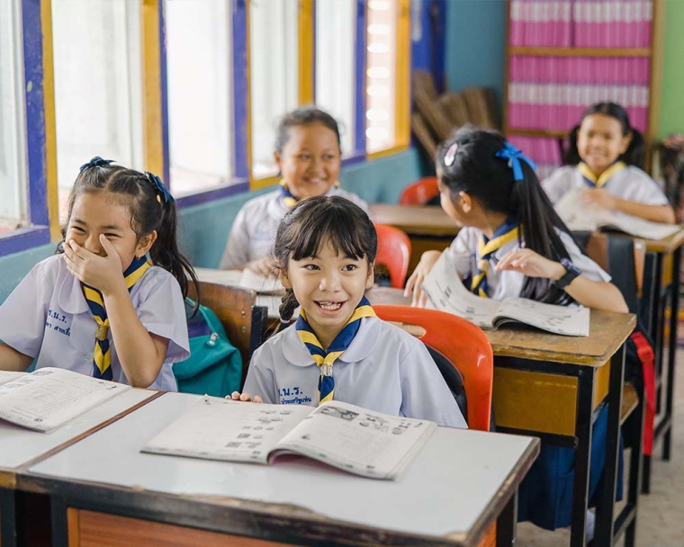 Pim smiling in school after cleft surgery