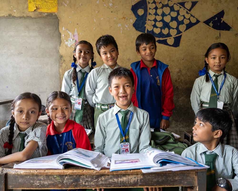 Pema smiling with his classmates after cleft surgery