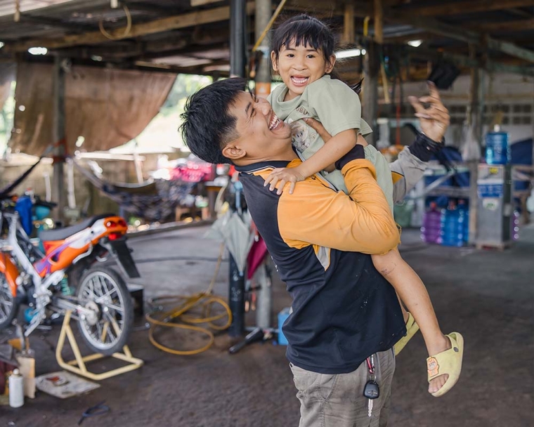Niu's father Not smiling and holding her after cleft surgery