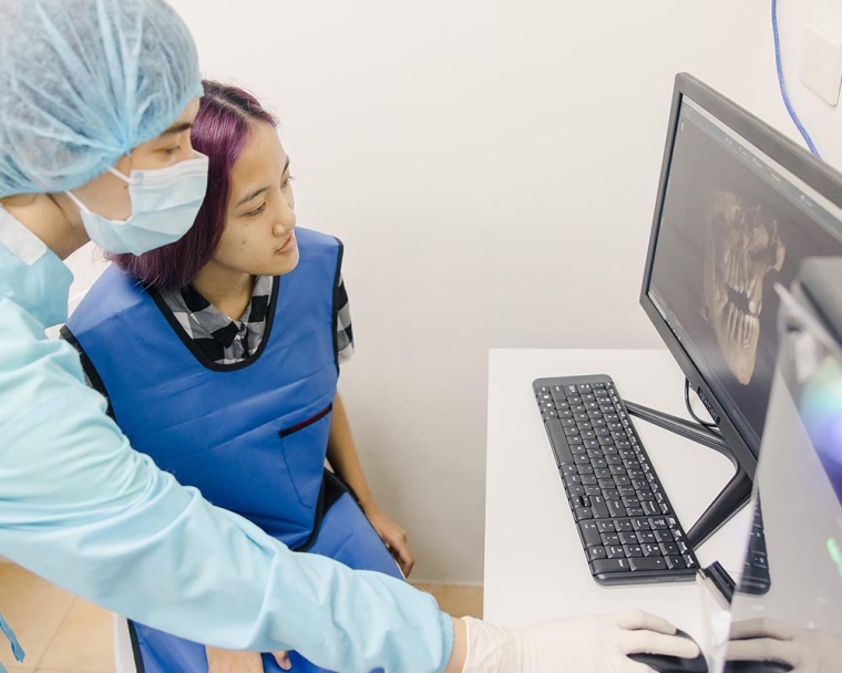 Dentist showing a cleft-affected patient their x-ray