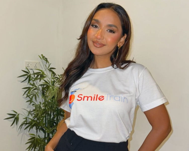 Jessica Zain smiling and wearing a Smile Train t-shirt